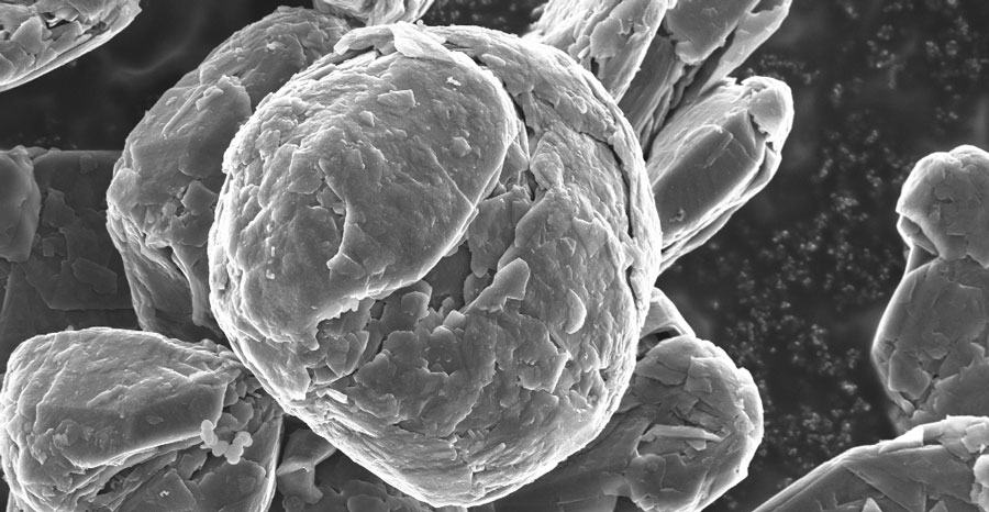Close-up of coated particle surface